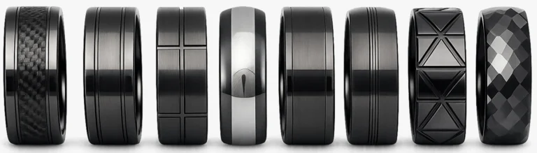 8 Black Zirconia Ceramic Rings standing upright in a line to show our range of black wedding rings