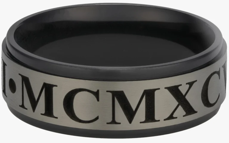 Laser engraved zirconium metal rings showing black and natural finish with Roman numeral engraving