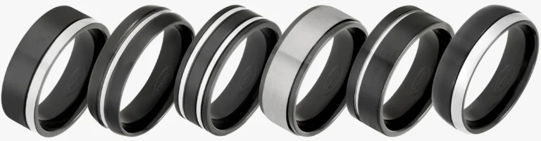 Row of 6 zirconium wedding rings showing black oxide and natural grey two tone designs
