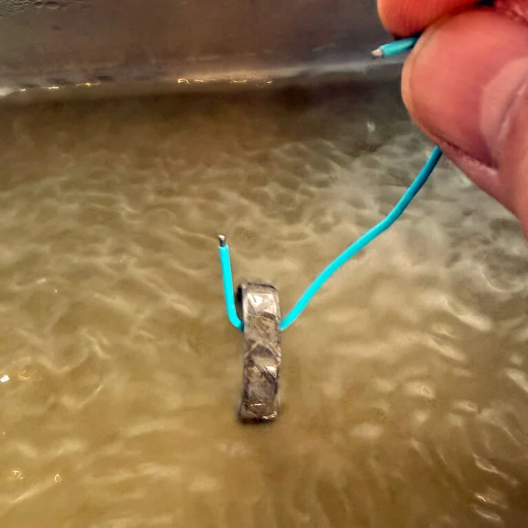 Meteorite ring being cleaned in an ultrasonic cleaning tank.